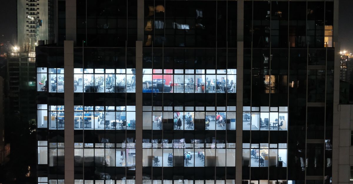 A night view of an office building in Central Visayas, Philippines, showcasing illuminated office windows.